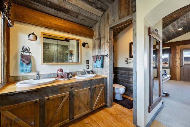 6 Browtine Ln, Ennis, MT 59729 - bathroom featuring wood ceiling, a wainscoted wall, toilet, and a sink