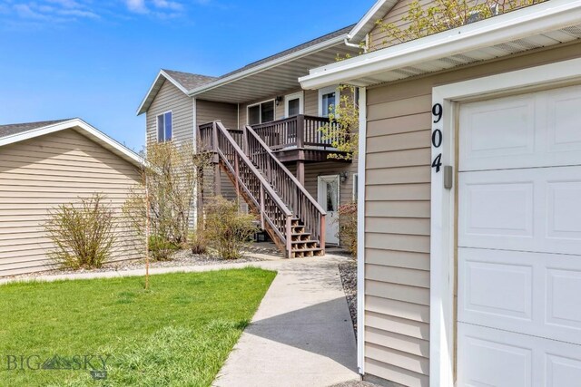 904 Jeanette Pl Unit 4, Belgrade, MT 59714 - doorway to property featuring a lawn, a deck, and a garage