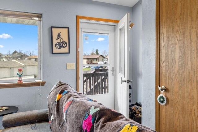 904 Jeanette Pl Unit 4, Belgrade, MT 59714 - doorway to outside featuring a wealth of natural light and a textured wall