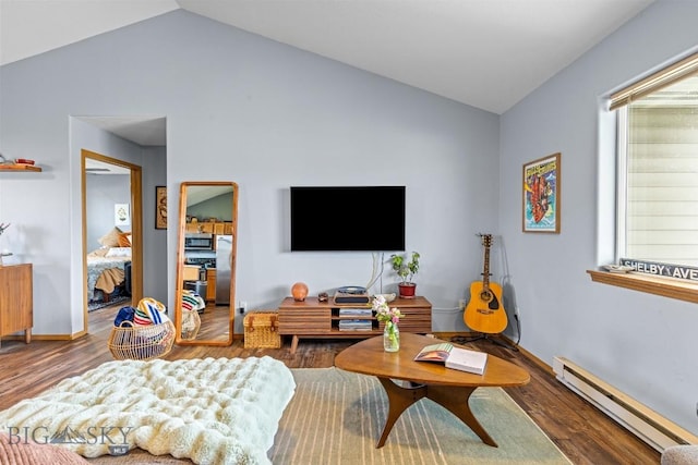 904 Jeanette Pl Unit 4, Belgrade, MT 59714 - living area with lofted ceiling, wood finished floors, a healthy amount of sunlight, and a baseboard heating unit