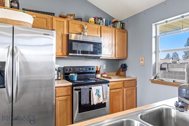 904 Jeanette Pl Unit 4, Belgrade, MT 59714 - kitchen featuring appliances with stainless steel finishes, light countertops, cooling unit, and vaulted ceiling