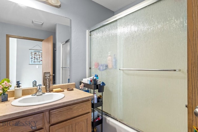 904 Jeanette Pl Unit 4, Belgrade, MT 59714 - bathroom with shower / bath combination with glass door, visible vents, and vanity