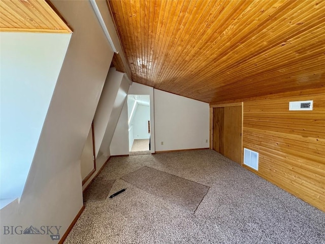bonus room featuring visible vents, wooden walls, carpet floors, and wood ceiling