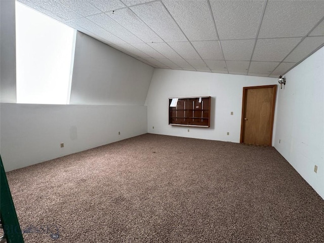 unfurnished living room with carpet and vaulted ceiling