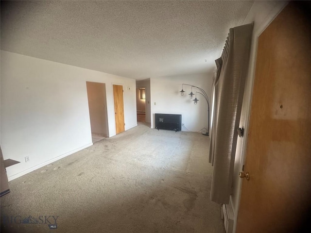 unfurnished living room with a textured ceiling and carpet
