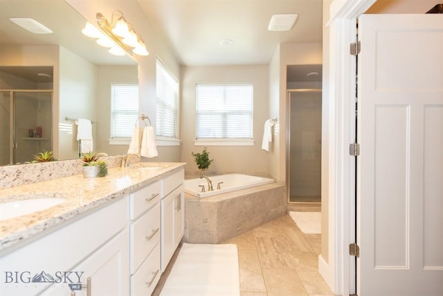 bathroom with a bath, a stall shower, double vanity, and a sink