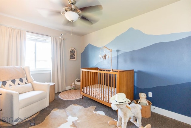 bedroom featuring a ceiling fan, carpet flooring, a nursery area, and baseboards