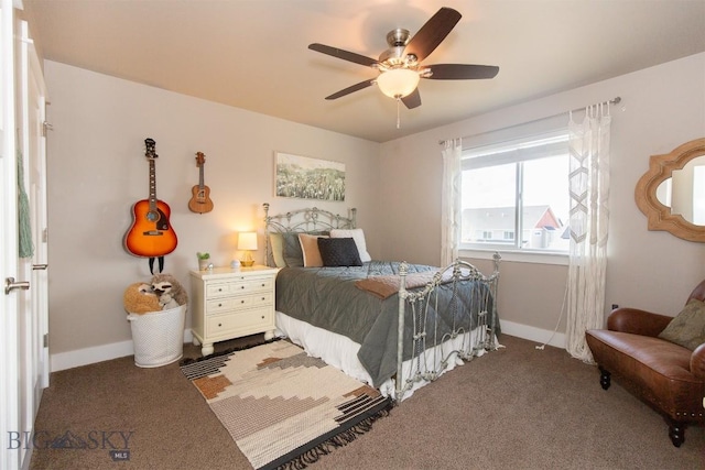 carpeted bedroom with a ceiling fan and baseboards