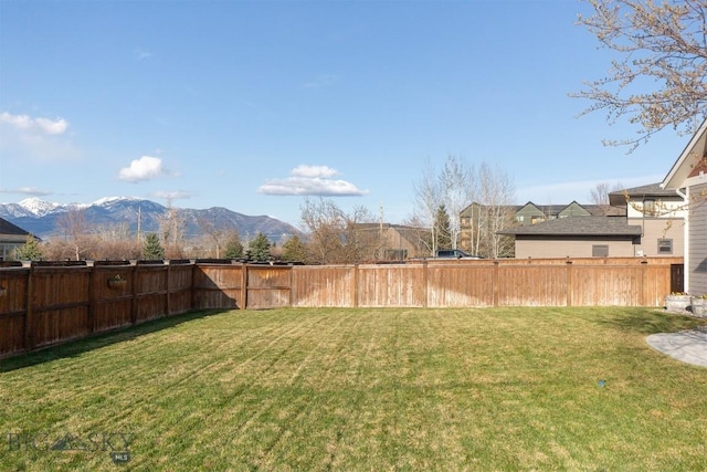 view of yard with a mountain view and fence
