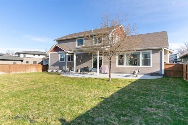 rear view of property with a patio, a lawn, and a fenced backyard