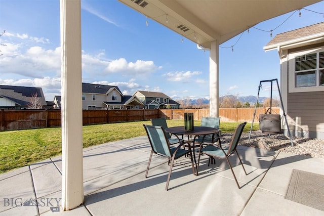 view of patio with outdoor dining area and a fenced backyard