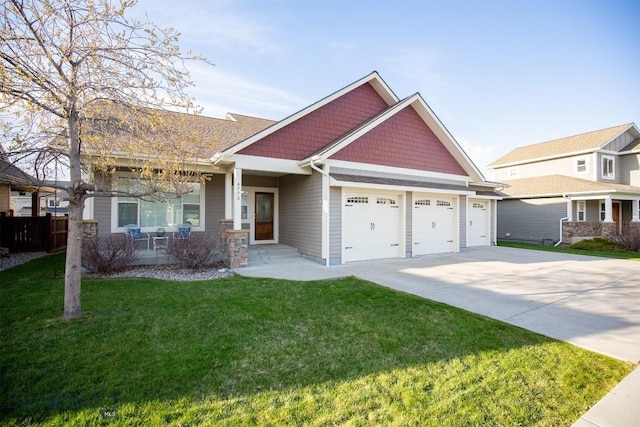 craftsman-style home with covered porch, a front yard, concrete driveway, and an attached garage