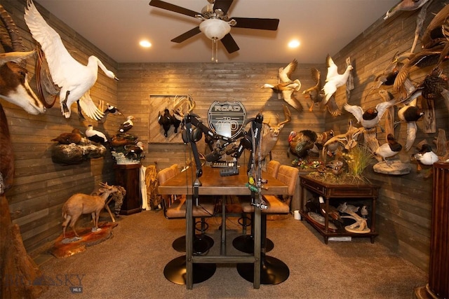 wine room with recessed lighting, wooden walls, ceiling fan, and carpet floors