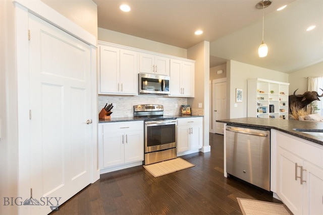 kitchen featuring tasteful backsplash, decorative light fixtures, appliances with stainless steel finishes, dark wood-style flooring, and white cabinetry