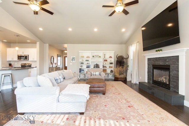 living room featuring a fireplace, a ceiling fan, dark wood-style floors, and recessed lighting