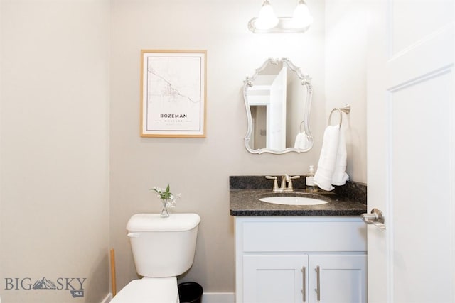 bathroom featuring toilet and vanity