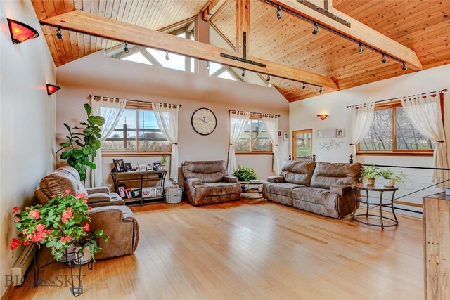 726 US Highway 10 W, Livingston, MT 59047 - living room with rail lighting, wooden ceiling with exposed beams, healthy amount of natural light, wood finished floors, and high vaulted ceiling