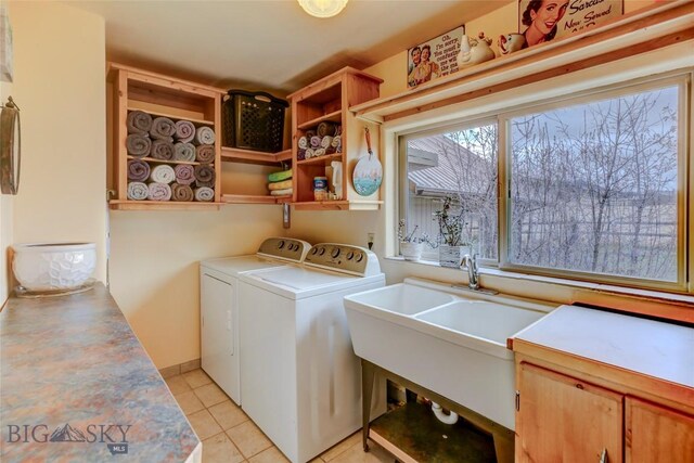 726 US Highway 10 W, Livingston, MT 59047 - laundry room featuring washer and dryer, light tile patterned flooring, and cabinet space