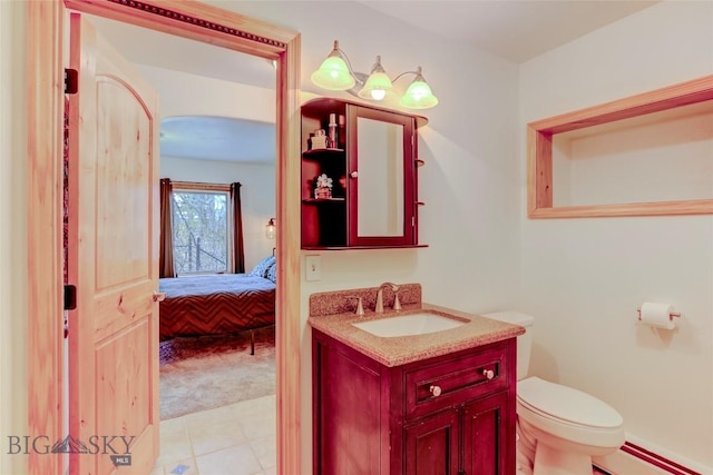 726 US Highway 10 W, Livingston, MT 59047 - half bathroom with vanity, toilet, ensuite bath, and a baseboard heating unit