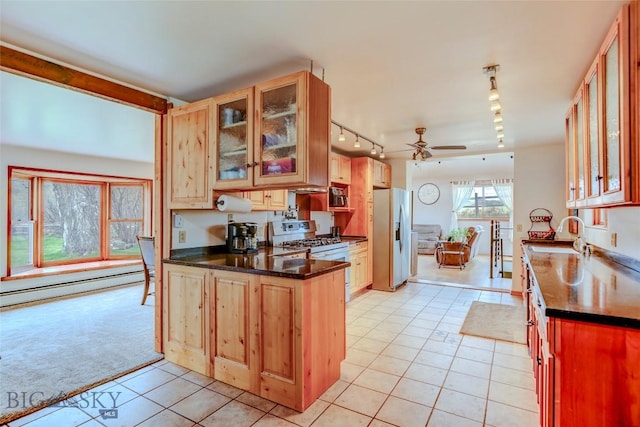 726 US Highway 10 W, Livingston, MT 59047 - kitchen with appliances with stainless steel finishes, track lighting, a sink, light tile patterned flooring, and a baseboard radiator