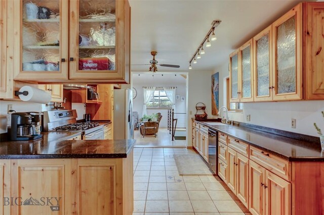 726 US Highway 10 W, Livingston, MT 59047 - kitchen featuring gas range gas stove, a sink, stainless steel fridge, ceiling fan, and light tile patterned floors