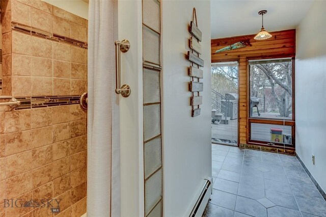 726 US Highway 10 W, Livingston, MT 59047 - bathroom with a baseboard radiator, tiled shower, and tile patterned flooring