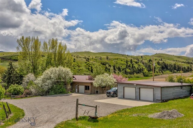 726 US Highway 10 W, Livingston, MT 59047 - view of front of house featuring a detached garage and driveway