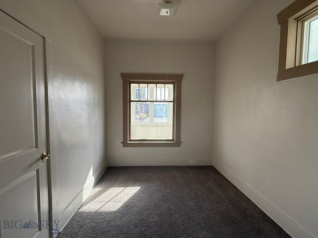 spare room featuring baseboards and carpet floors