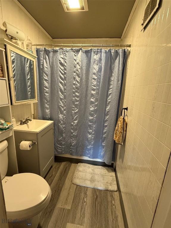 2900 Kennedy, Butte, MT 59701 - bathroom with a shower with curtain, visible vents, toilet, wood finished floors, and vanity