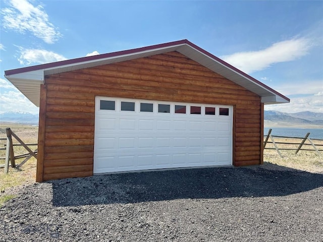 garage featuring a mountain view and fence