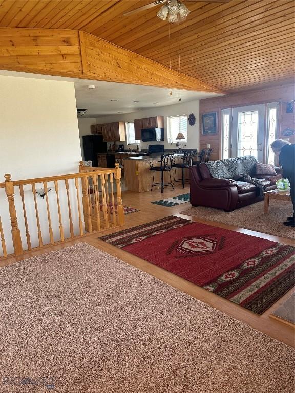 living room with wood ceiling and ceiling fan