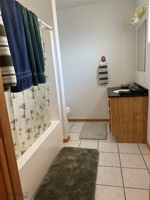 full bath with toilet, tile patterned floors, shower / bath combination with curtain, and vanity