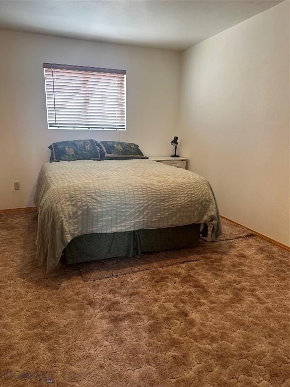carpeted bedroom with baseboards
