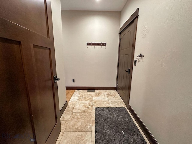 hall featuring baseboards