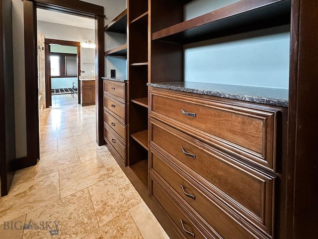 spacious closet with stone finish flooring
