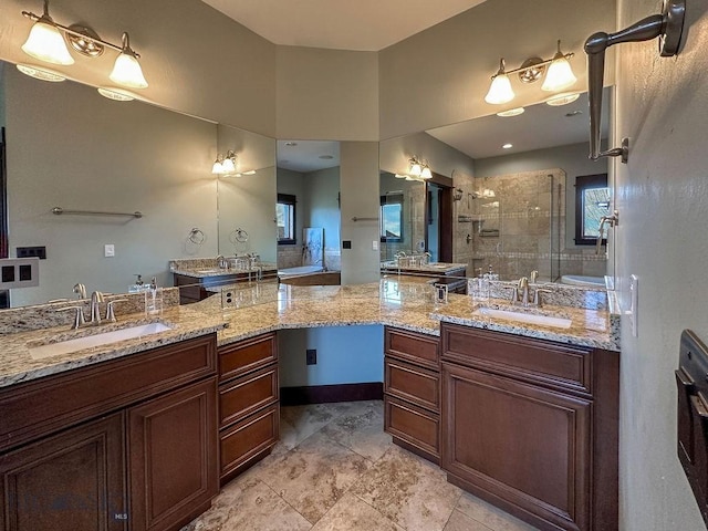 full bath featuring two vanities, a sink, and a shower stall