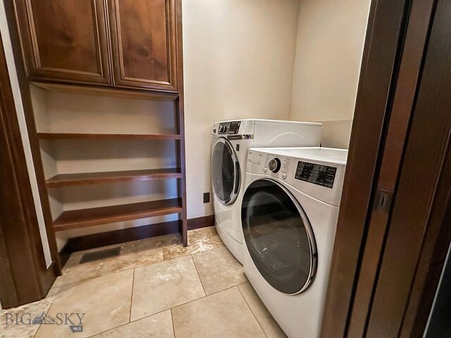 washroom with baseboards, cabinet space, light tile patterned flooring, and independent washer and dryer