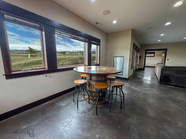 dining room featuring baseboards, recessed lighting, visible vents, and concrete flooring