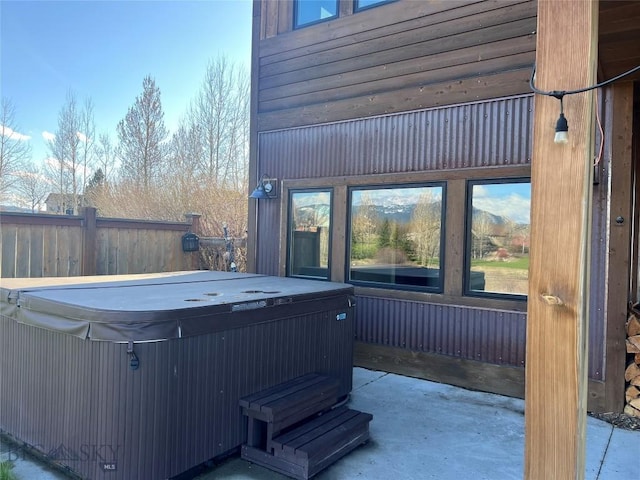 exterior space with a patio, fence, and a hot tub