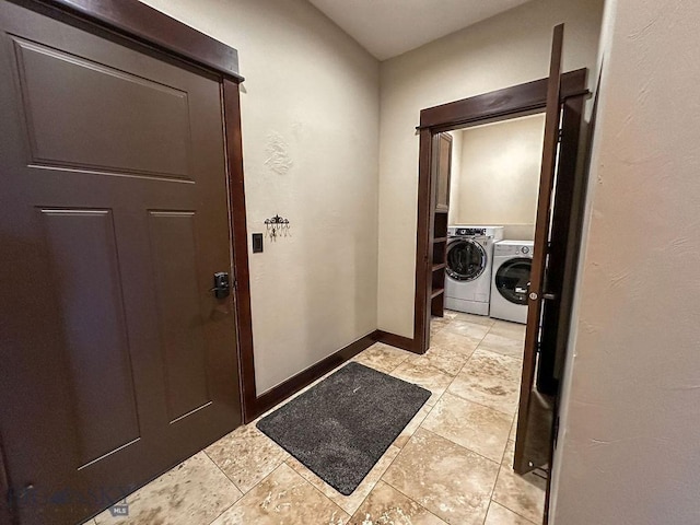 laundry area featuring baseboards, laundry area, and independent washer and dryer