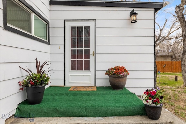 entrance to property featuring fence