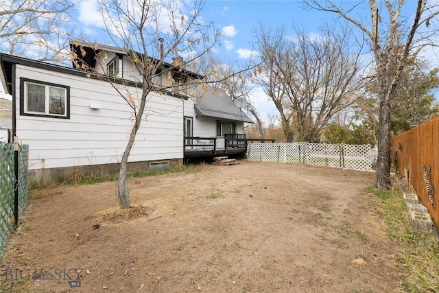 view of yard featuring a fenced backyard and a wooden deck