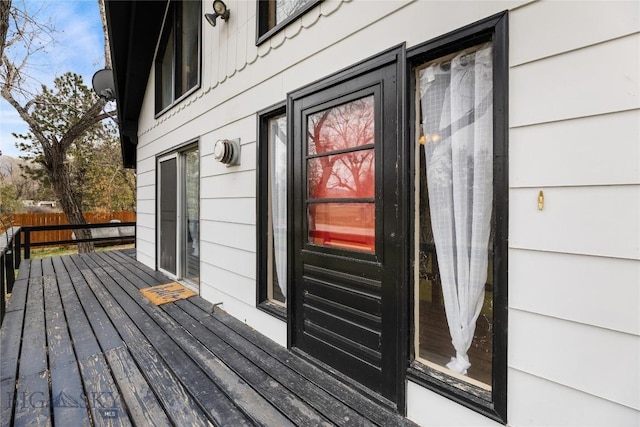 exterior space featuring fence and a deck
