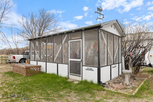 view of outdoor structure featuring a sunroom