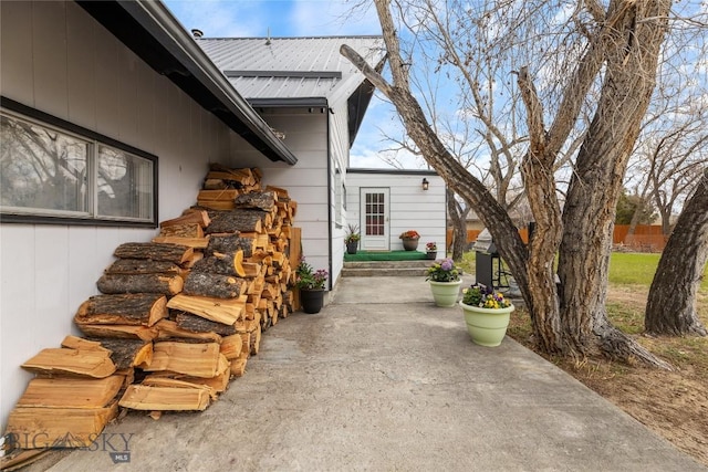 view of home's exterior with a patio and metal roof