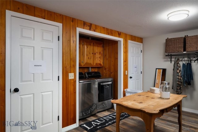 7550 Springhill Rd, Belgrade, MT 59714 - kitchen with brown cabinetry, wood finished floors, baseboards, wooden walls, and washer and clothes dryer