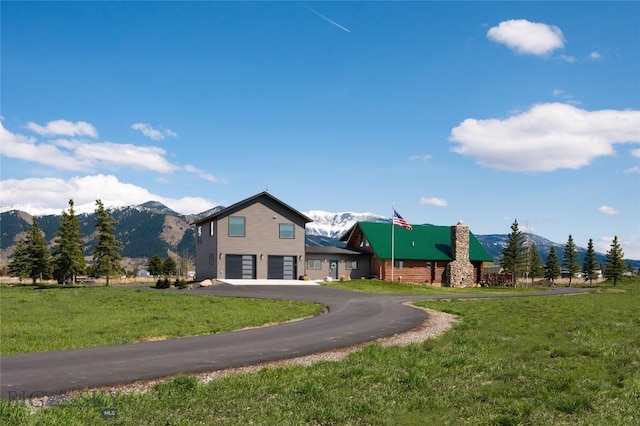 7550 Springhill Rd, Belgrade, MT 59714 - view of front facade featuring an attached garage, a mountain view, driveway, and a front yard