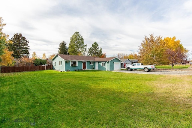 single story home with an attached garage, fence, driveway, and a front yard