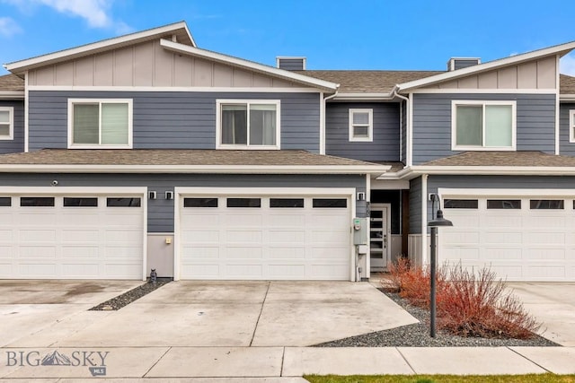 1307 Grover Ln Unit B, Belgrade, MT 59714 - multi unit property with board and batten siding, concrete driveway, an attached garage, and a chimney