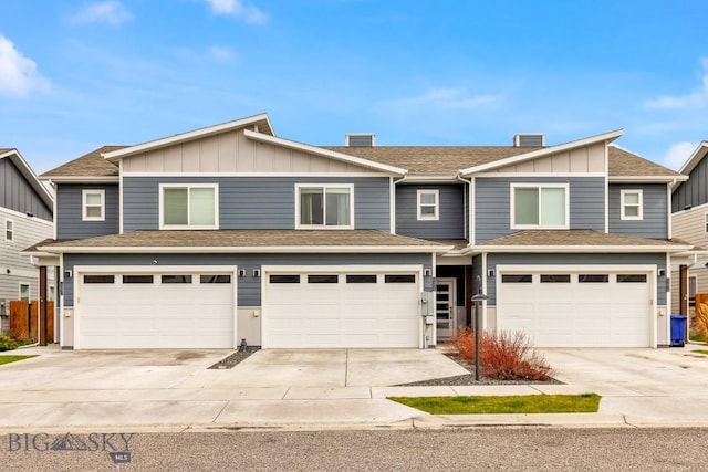 1307 Grover Ln Unit B, Belgrade, MT 59714 - view of front of property featuring an attached garage, board and batten siding, and concrete driveway